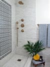 marble tile bathroom with black mosaic inlay