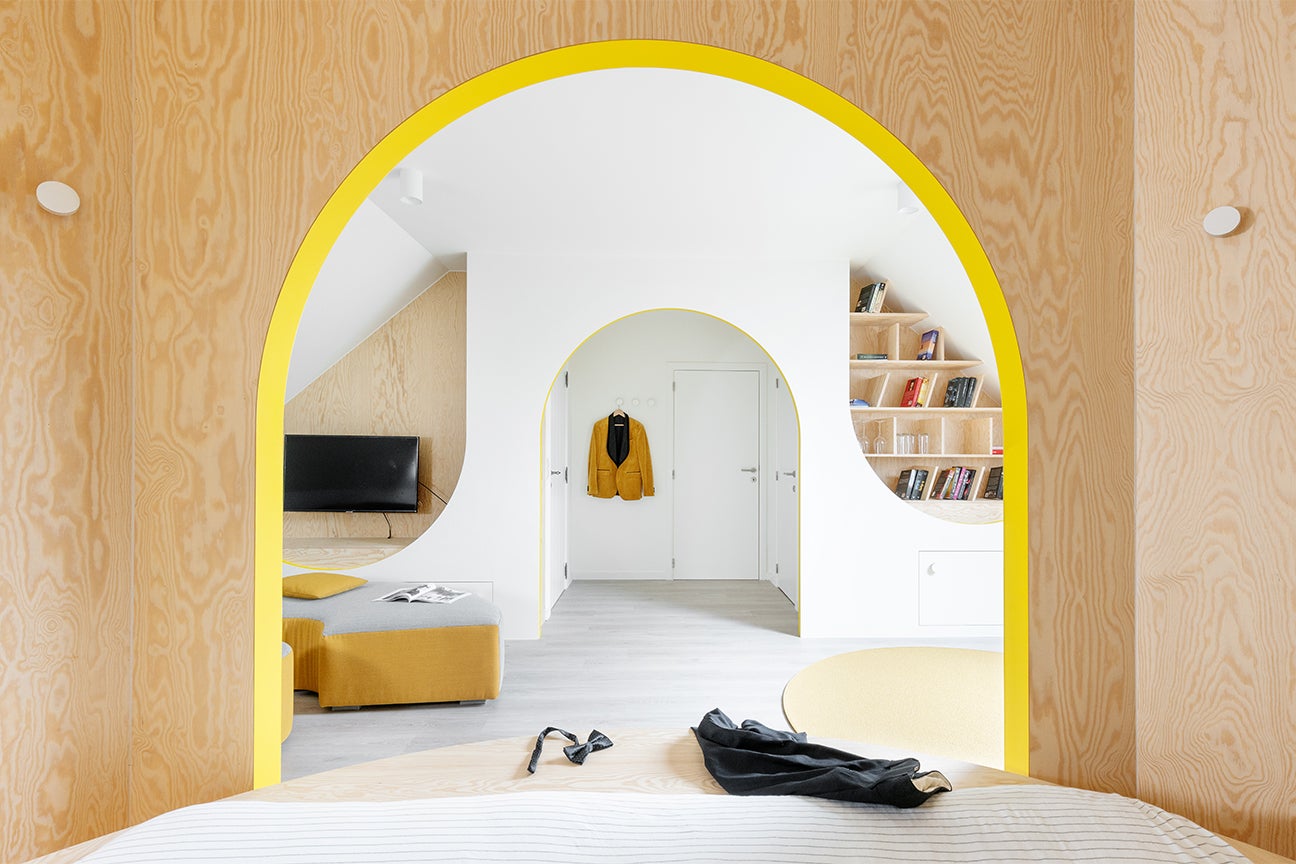 plywood wall and yellow arch
