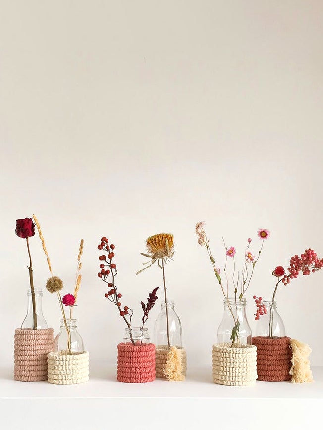 pink vases with flowers lined up