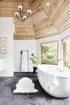 sloped ceiling bathroom with giant white tub
