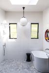 white and grey bathroom with long ceiling pendant