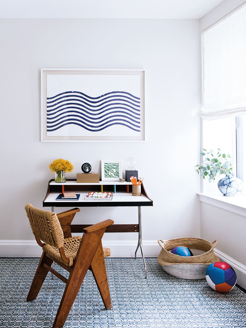 white office with blue artwork hanging