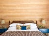 Bedroom with wood-paneled walls