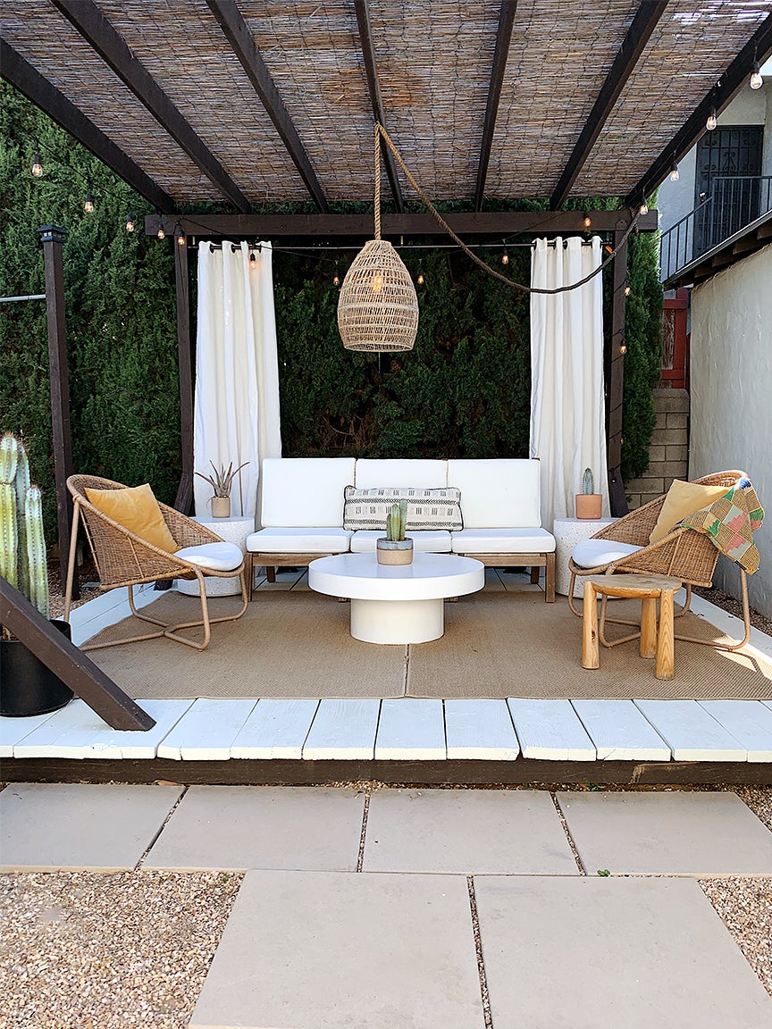 white deck with jute rug and other earthy furniture