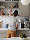 Kitchen with gray cabinets and herringbone backsplash
