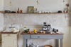 white kitchen with grey antique workbench