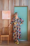 Jen Mankins in floral dress in front of turquoise door