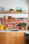 wood kitchen with multicolor tile backsplash
