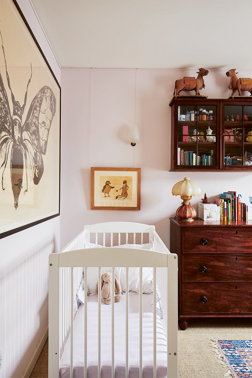 pink nursery with large butterfly art