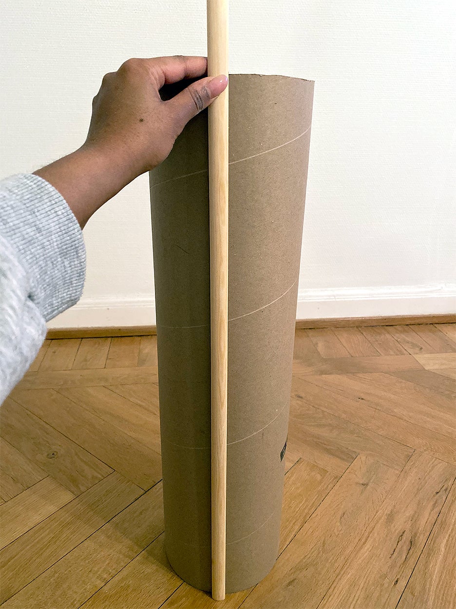 wood dowel held against cardboard tube