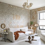 neutral living room with antique wallpaper and white sofa