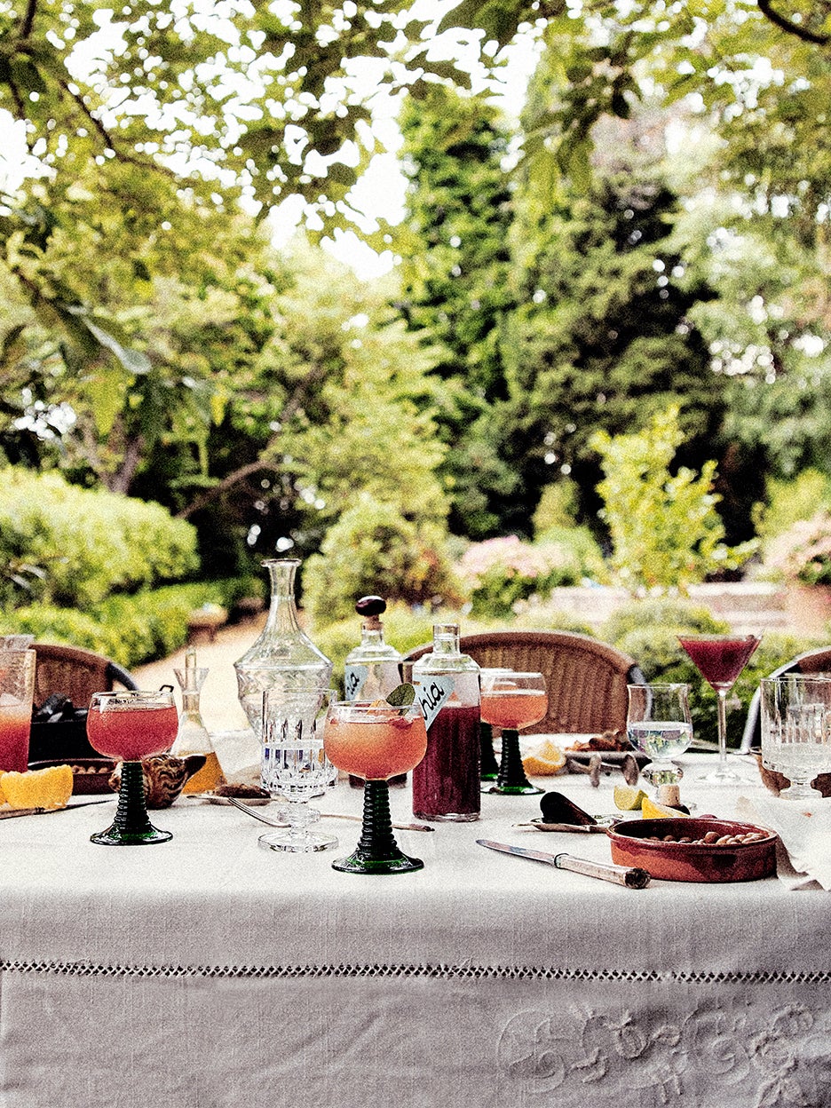 outdoor dinner table with cocktails and food