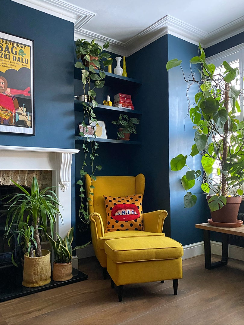 blue living room with fireplace and yellow arm chair