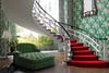 greenbrier hotel staircase with red carpet and green wallpaper