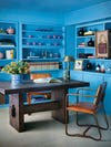 bright blue wall colors and built-in bookshelf in home office