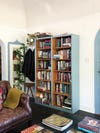 living room with wooden bookcase painted blue