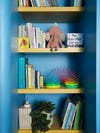 blue and yellow bookshelf for nursery