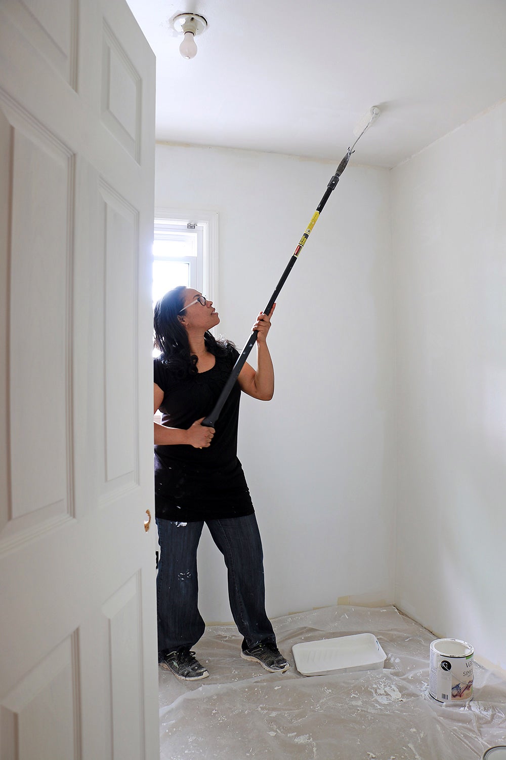 woman scraping ceiling