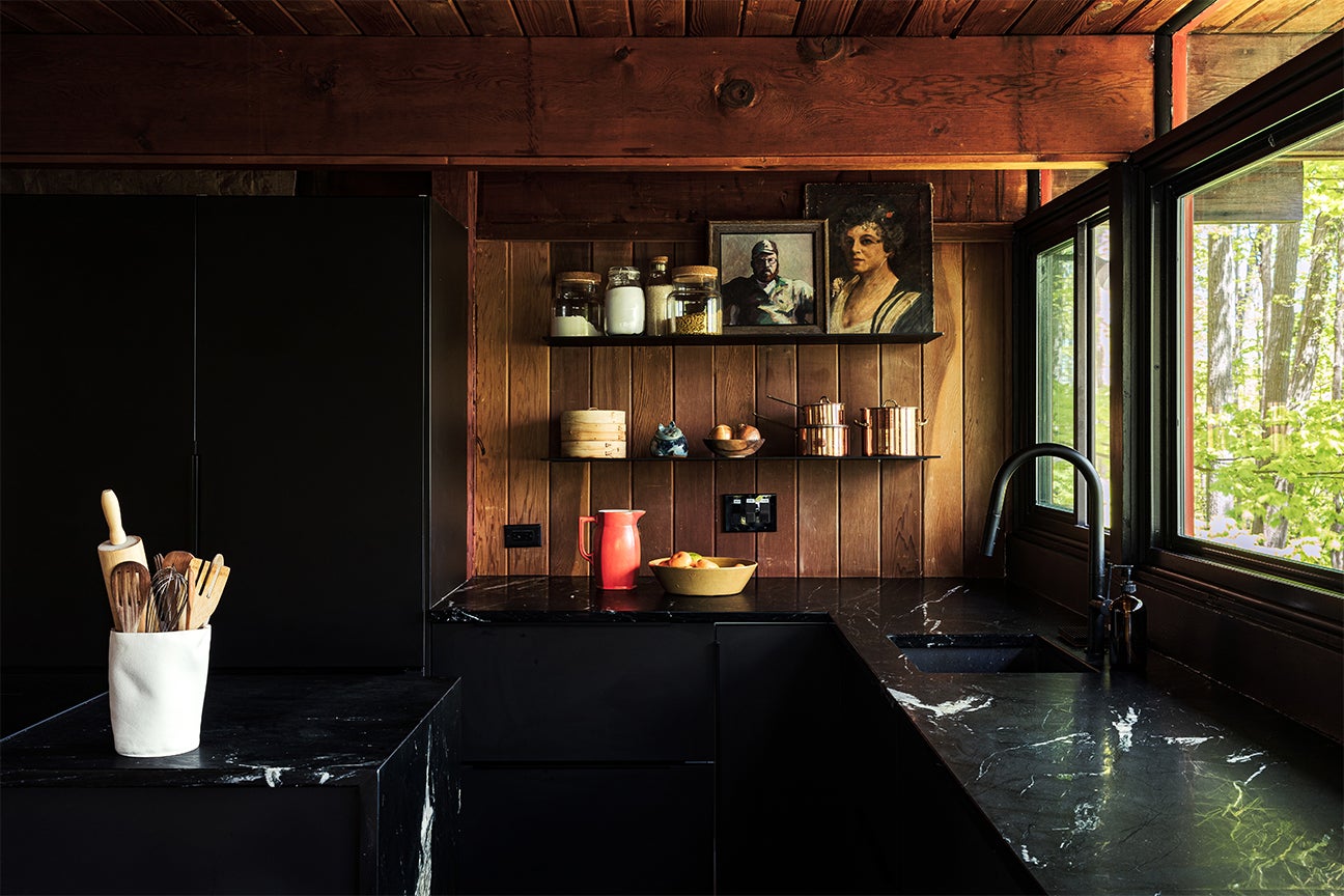black kitchen with wood panel walls