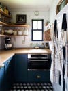 navy blue kitchen cabinets with butcher block counters