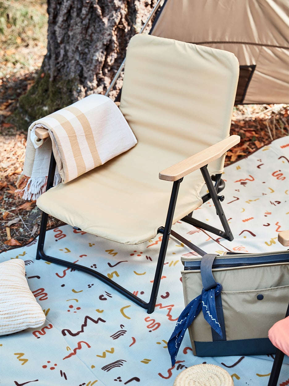 yellow lawn chair on top of picnic blanket