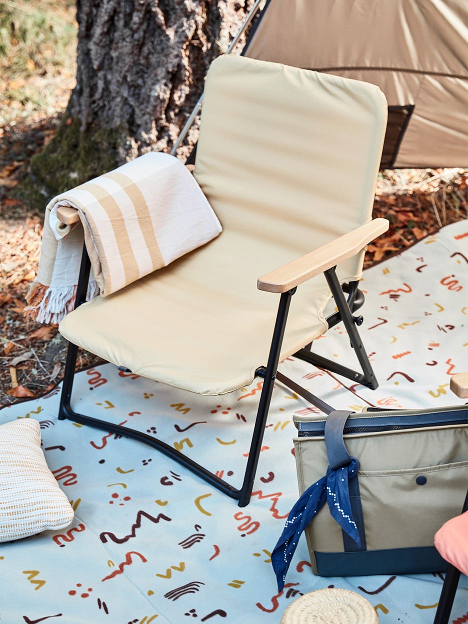 yellow lawn chair on top of picnic blanket