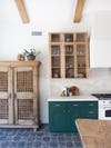 white rustic kitchen with antique wood cabinets and green cupboards