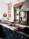 dark blue kitchen cabinets and antique upper cabinet
