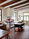 rustic kitchen with wood beams and antique island