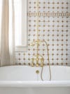 white and terra cotta zellige tiles behind bathtub