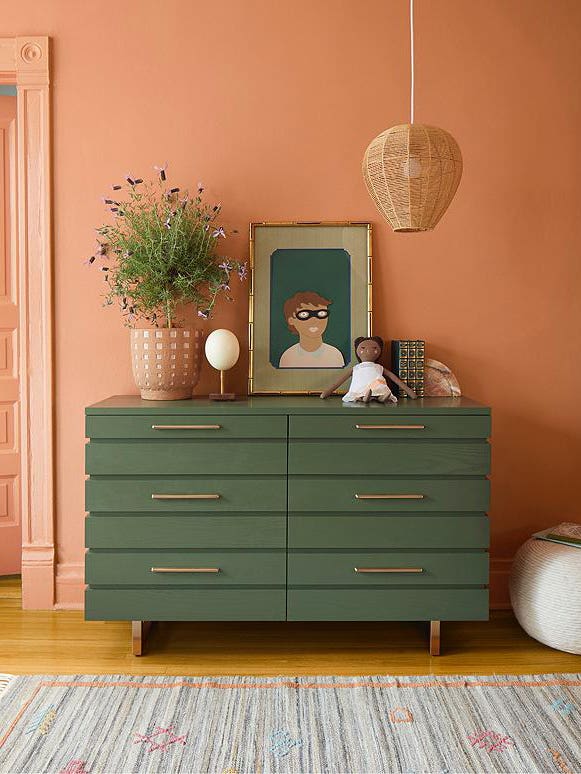 green dresser in front of coral walls