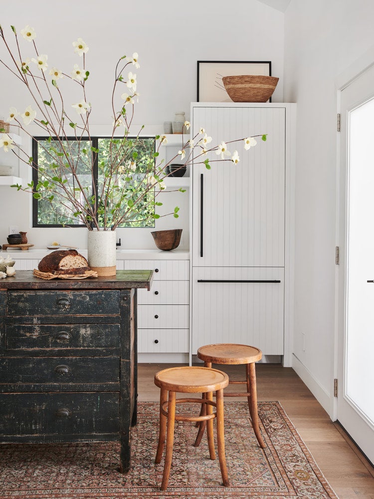 white kitchen with distressed wood island