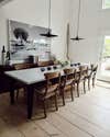 concrete dining room table with matte black pendants