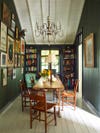 Dark green dining room with paneled walls