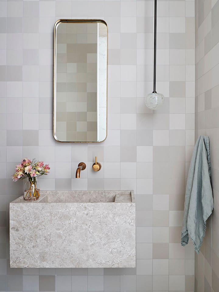 grey tile bathroom with rectangular mirror