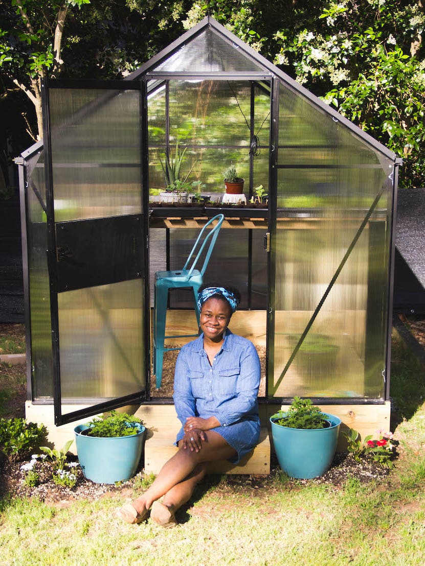 woman sitting in greenhouse door