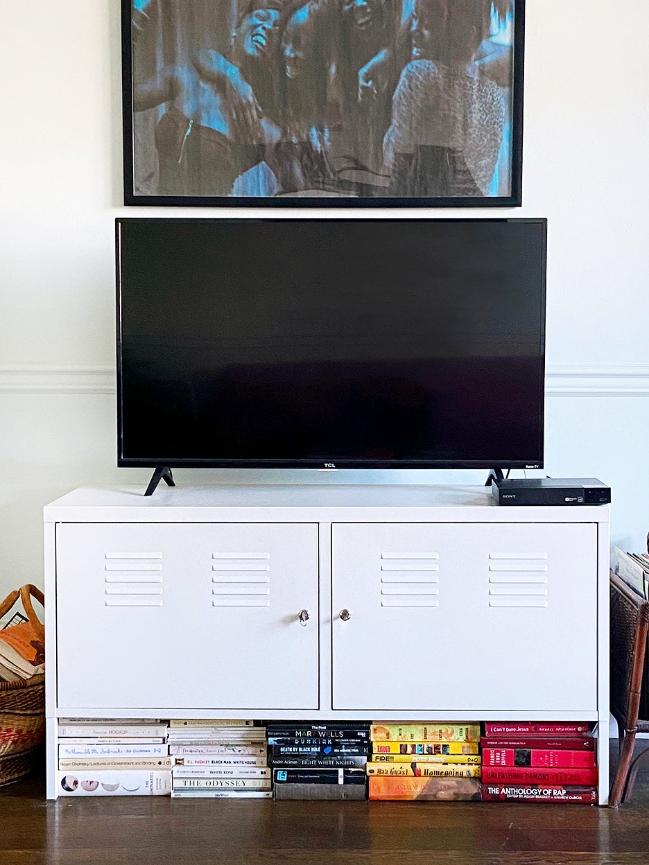 TV console with color-coordinated books underneath