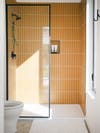 yellow glass tile shower nook