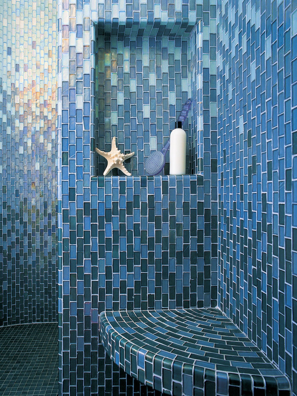 blue ombre tile bathroom with recessed wall nook for shampoo