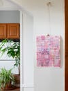 pink painting hanging from wall