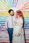couple with rainbow sunburst backdrop