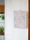 multicolored painting hanging from wall