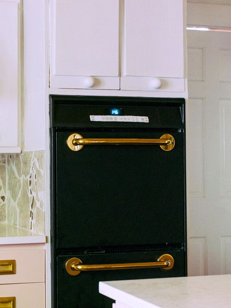 black oven with brass bars