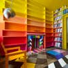 colorful library with ombre bookcases and floor mural