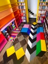 room with checkerboard floors that have a colorful mural painted over them