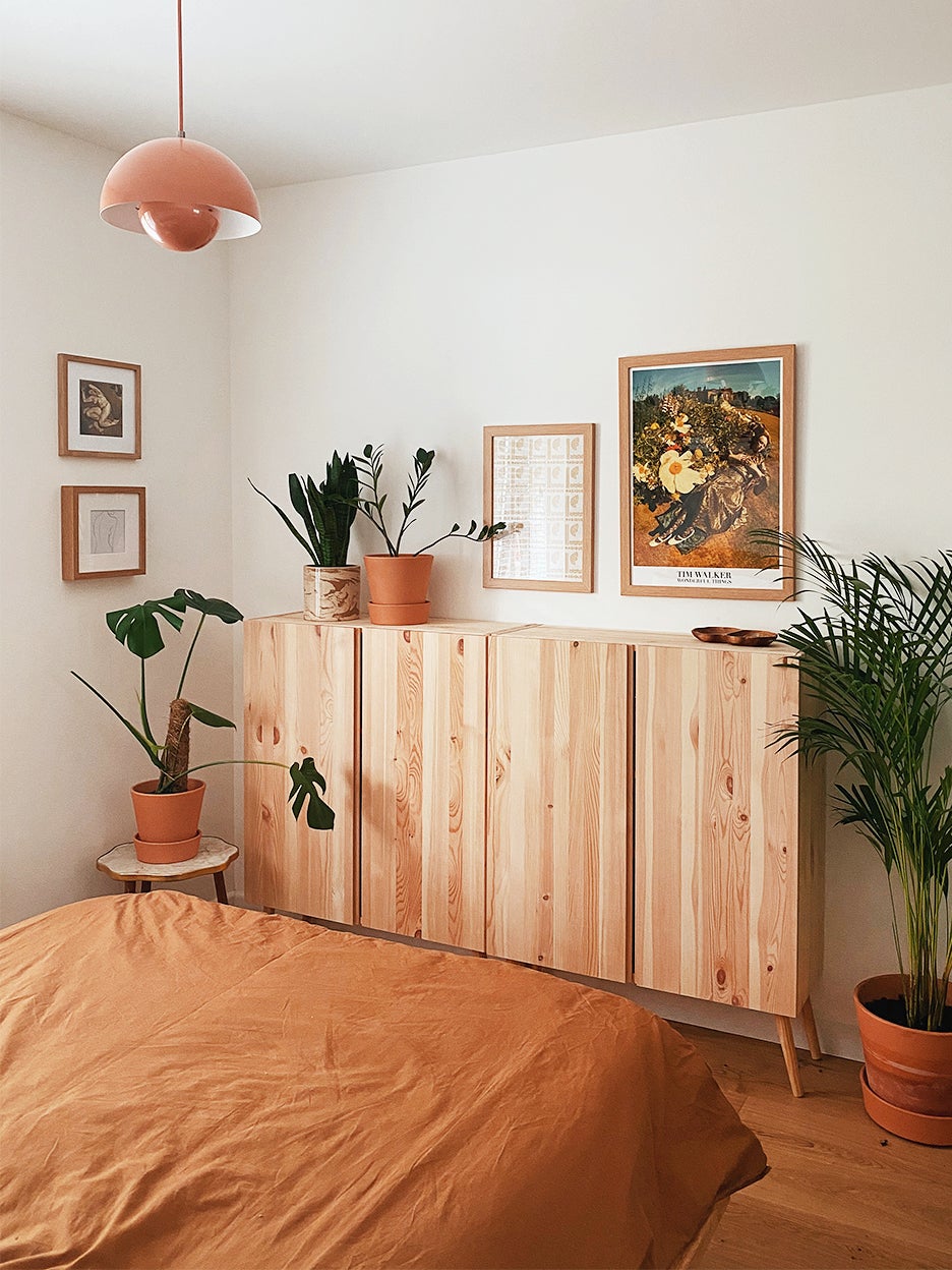 wood console in bedroom with terracotta bedding