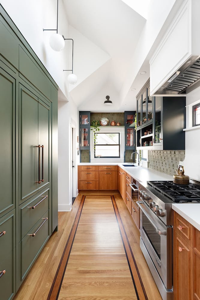long kitchen wiht green cabinets