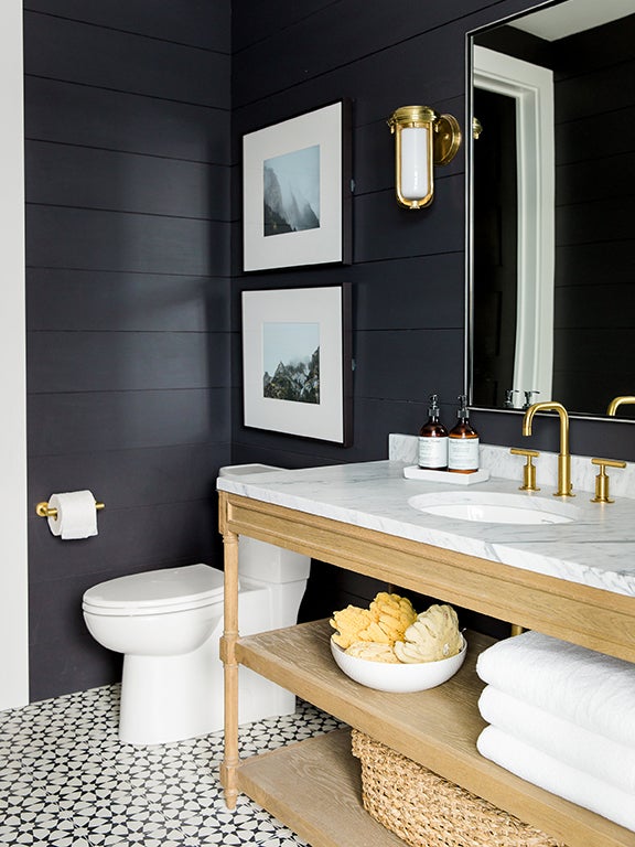 black bathroom with wooden sink fixture and white star tiles