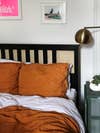 ikea bed frame with rust orange bedding