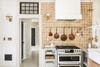 terracotta kitchen with copper pans above oven